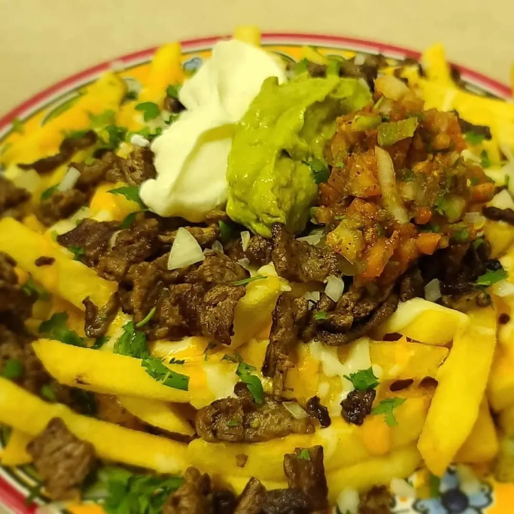 Carne asada fries topped with guacamole